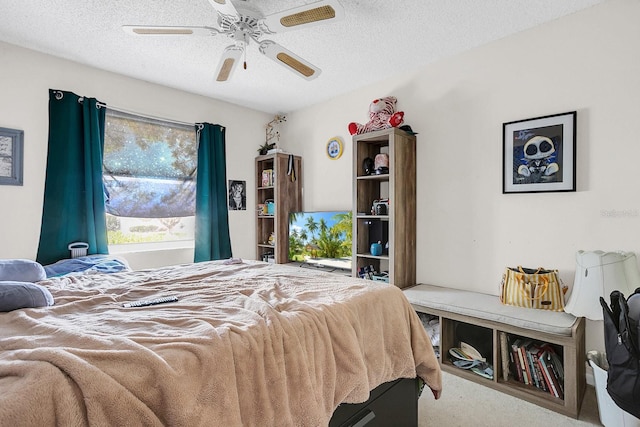 carpeted bedroom featuring ceiling fan and a textured ceiling