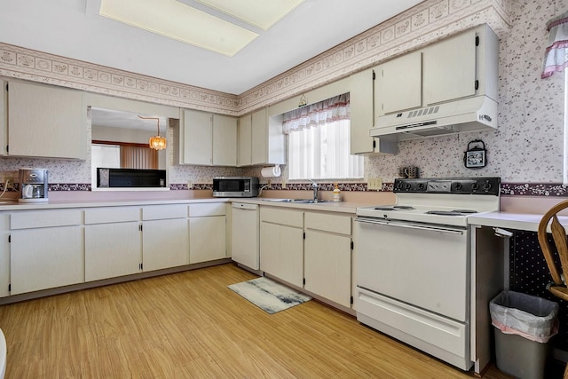 kitchen featuring light hardwood / wood-style floors, sink, white appliances, and custom range hood