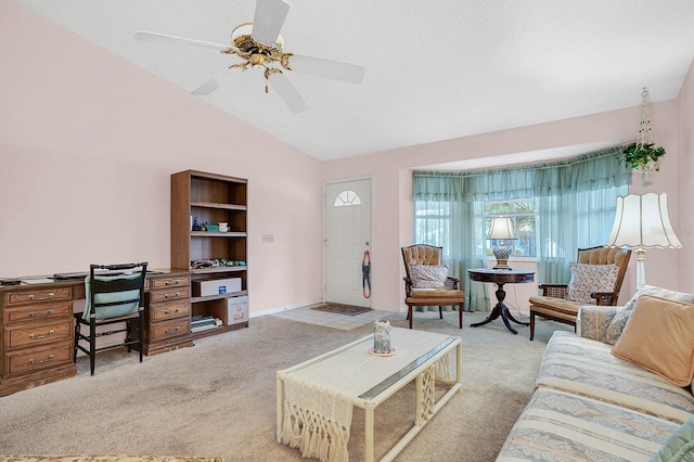 carpeted living room with ceiling fan and lofted ceiling