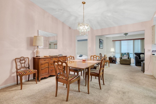 carpeted dining room featuring a notable chandelier