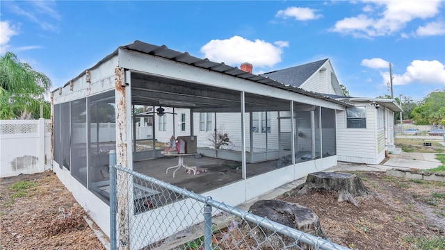 view of property exterior with a sunroom