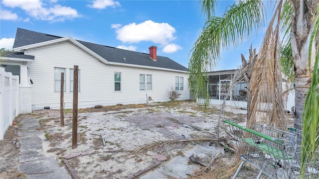 rear view of property featuring a sunroom