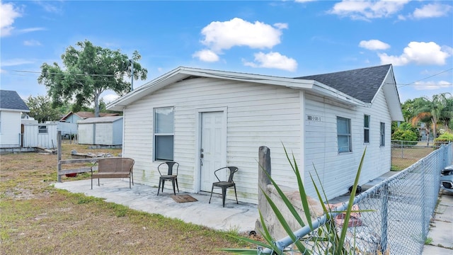 back of property with an outdoor structure