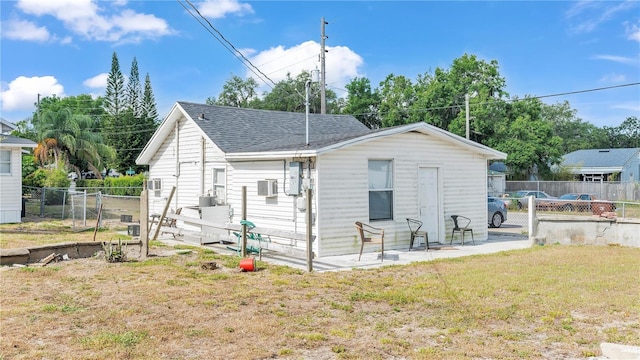 back of property with a patio and a yard