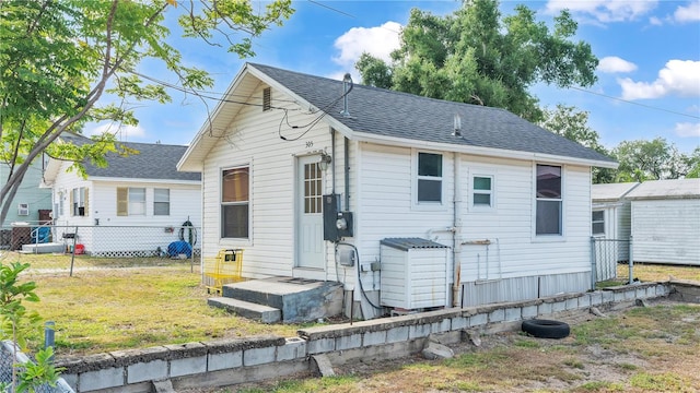 rear view of property with a yard