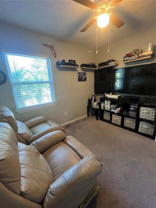 carpeted living room with a textured ceiling and ceiling fan