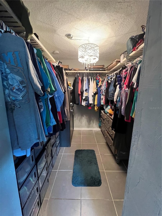 walk in closet with dark tile patterned floors