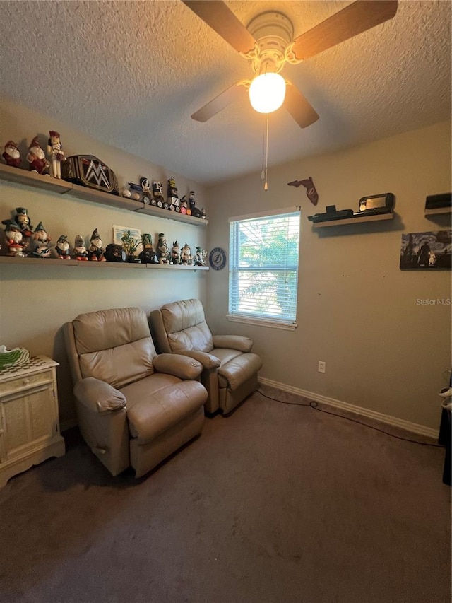 carpeted living room featuring ceiling fan and a textured ceiling