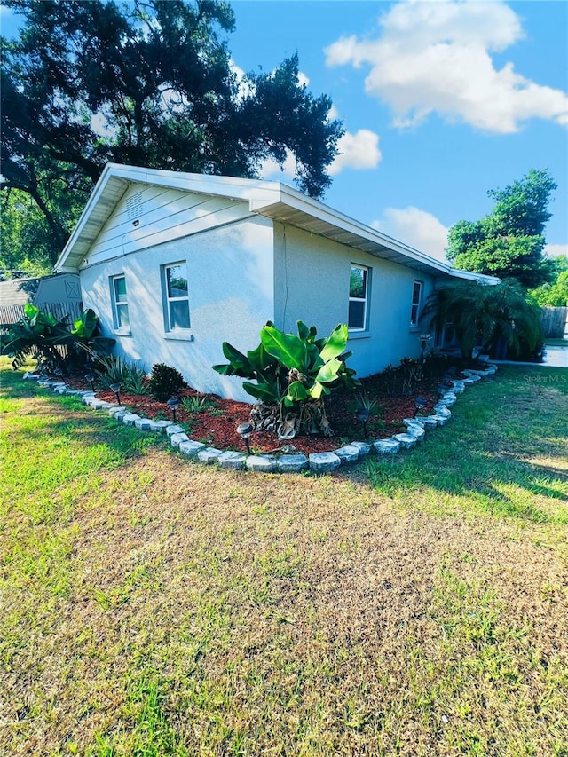 view of side of property with a yard