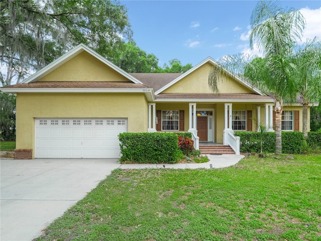 view of front facade with a garage, a front yard, and covered porch