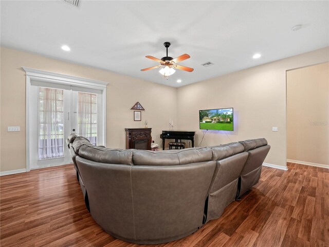 living room with hardwood / wood-style floors, ceiling fan, and french doors