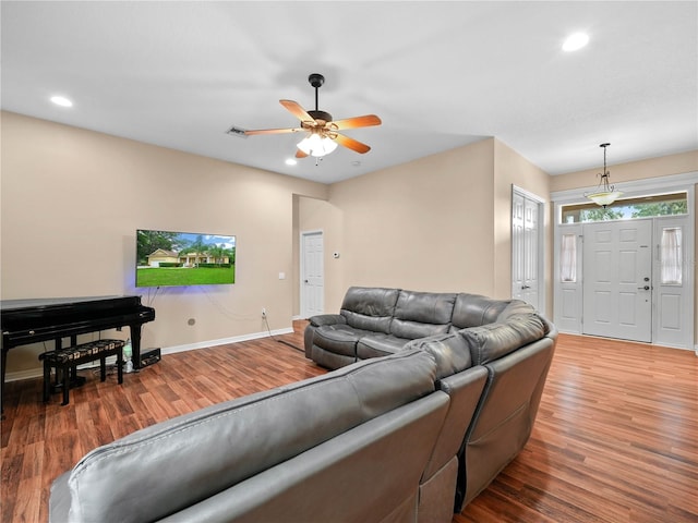 living room with ceiling fan and hardwood / wood-style flooring