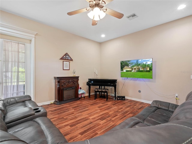 living room with hardwood / wood-style floors and ceiling fan