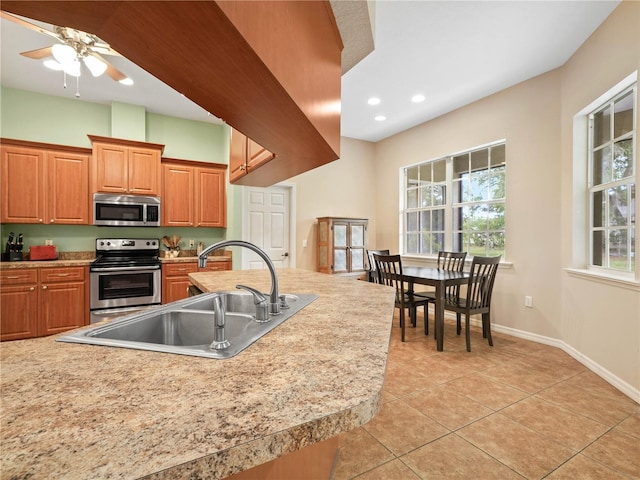 kitchen with ceiling fan, light tile floors, sink, and appliances with stainless steel finishes