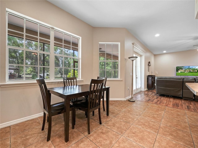 tiled dining area with a wealth of natural light and ceiling fan