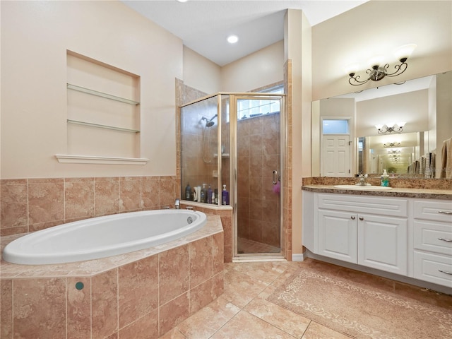 bathroom featuring large vanity, tile flooring, and separate shower and tub