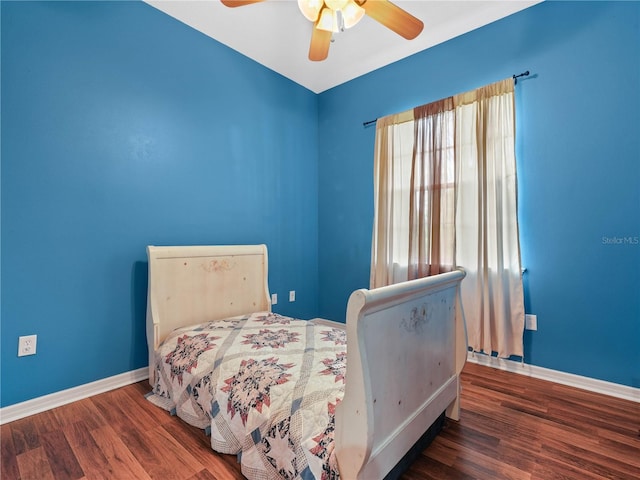 bedroom with dark hardwood / wood-style floors and ceiling fan