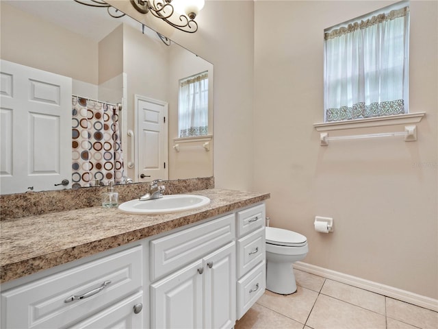 bathroom featuring tile flooring, toilet, and vanity