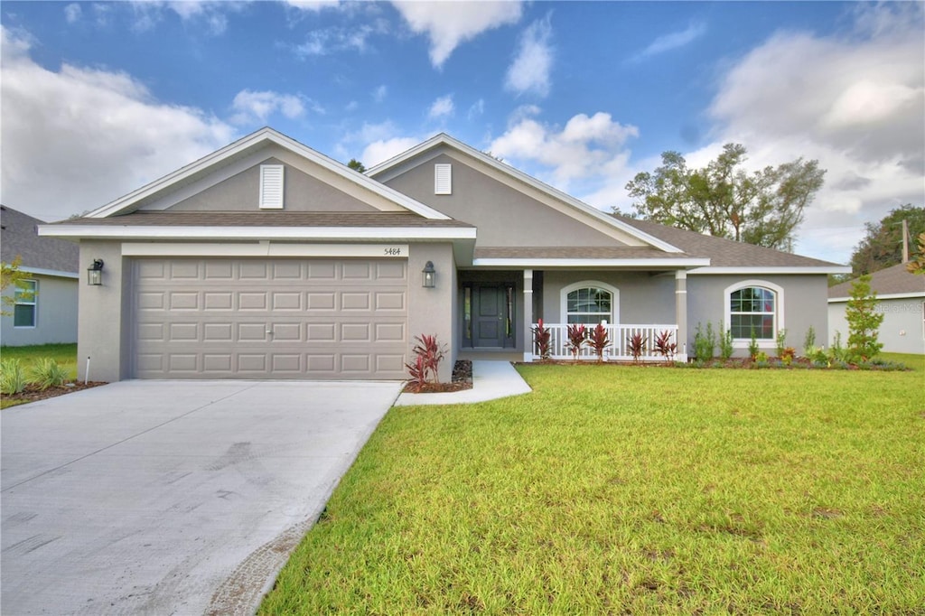 ranch-style home with a porch, a garage, and a front yard