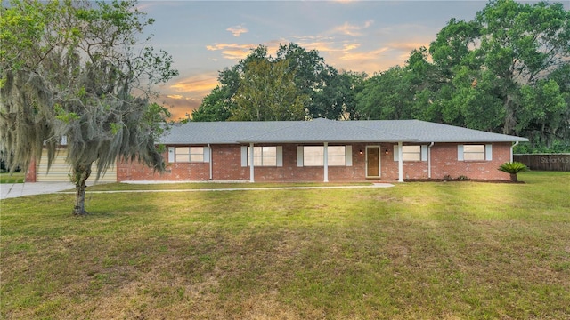 ranch-style home with a yard