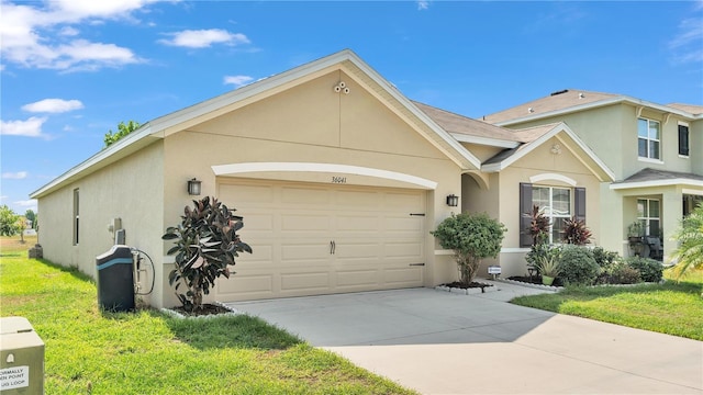 ranch-style home featuring a garage and a front lawn