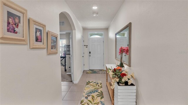 tiled entrance foyer with a textured ceiling