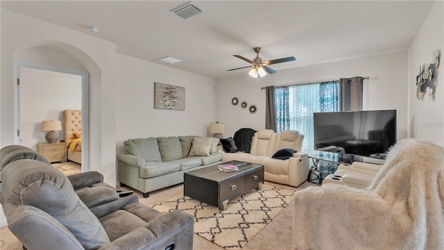 living room with ceiling fan and light colored carpet