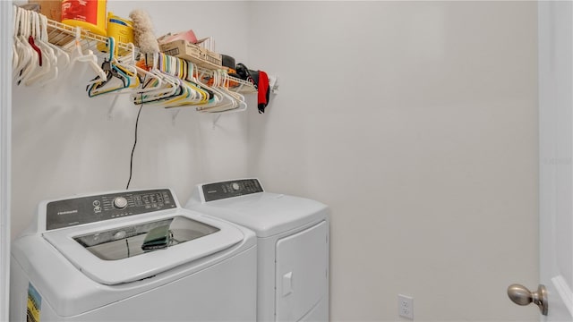 clothes washing area featuring washer and clothes dryer