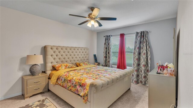 bedroom featuring light carpet and ceiling fan