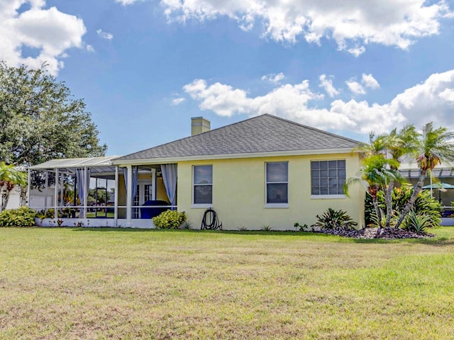 rear view of house with a yard