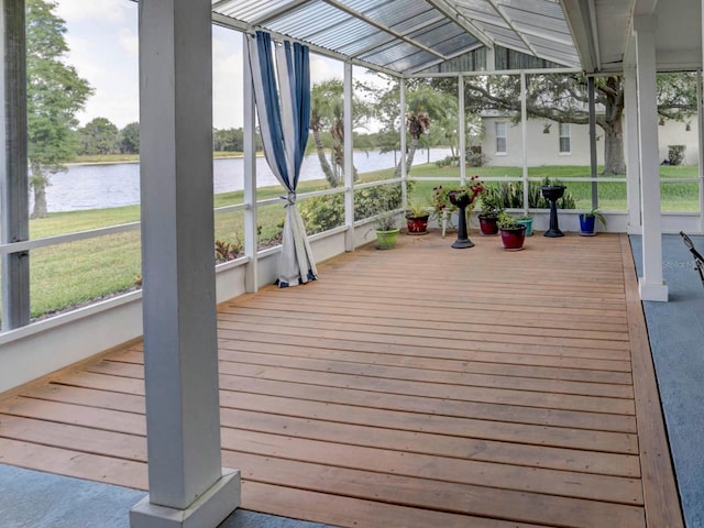 unfurnished sunroom with lofted ceiling and a water view