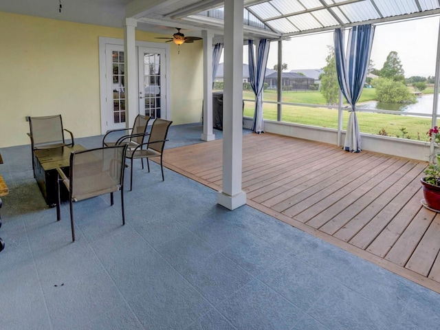 wooden terrace with ceiling fan and french doors