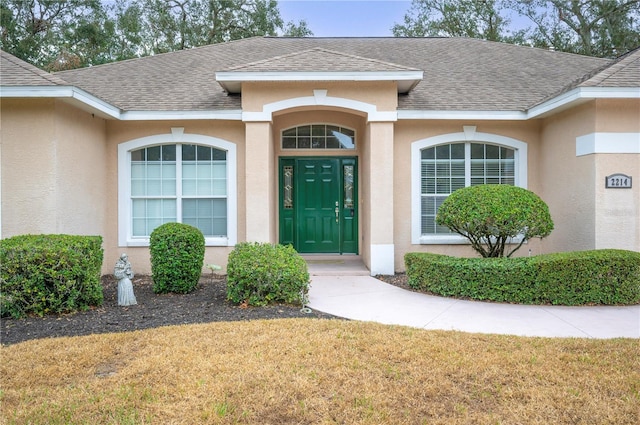 doorway to property featuring a yard