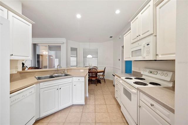 kitchen featuring white cabinetry, sink, light tile patterned flooring, and white appliances