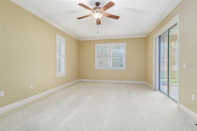 empty room with light colored carpet, ceiling fan, and crown molding