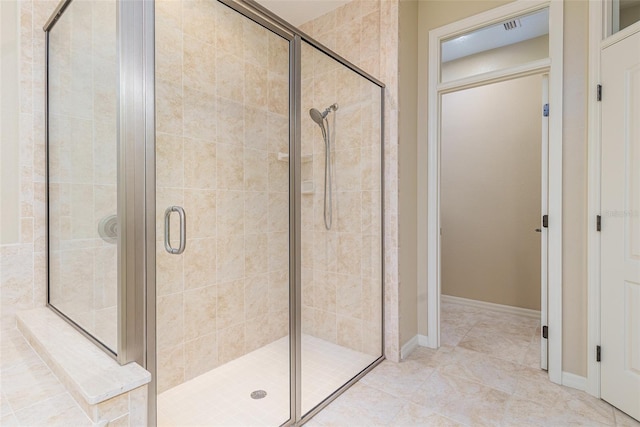 bathroom with tile patterned floors and walk in shower