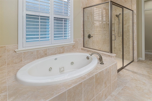 bathroom featuring tile patterned flooring and independent shower and bath