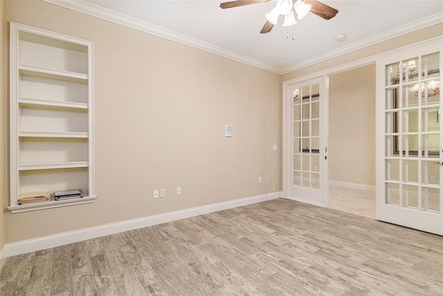 unfurnished room with crown molding, built in features, light hardwood / wood-style flooring, and french doors