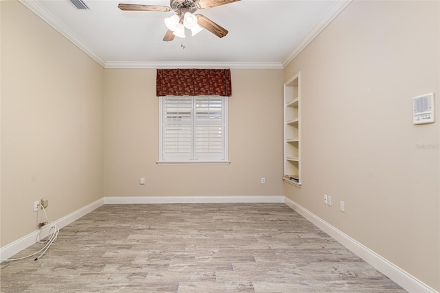 spare room with crown molding, built in features, ceiling fan, and light wood-type flooring