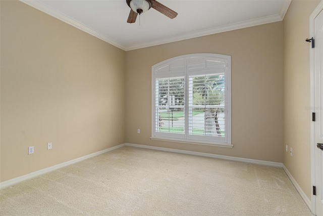 empty room featuring light colored carpet, ceiling fan, and crown molding