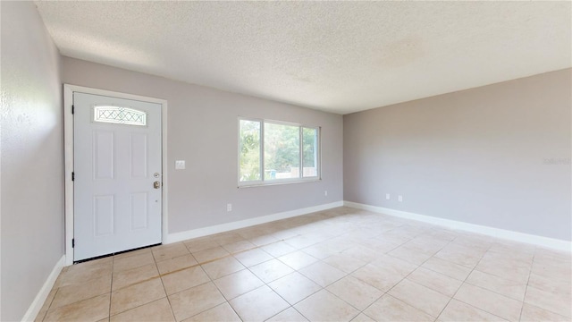 foyer featuring a textured ceiling and light tile flooring