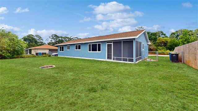 rear view of house with a yard