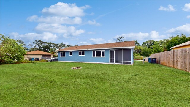 back of property featuring a lawn