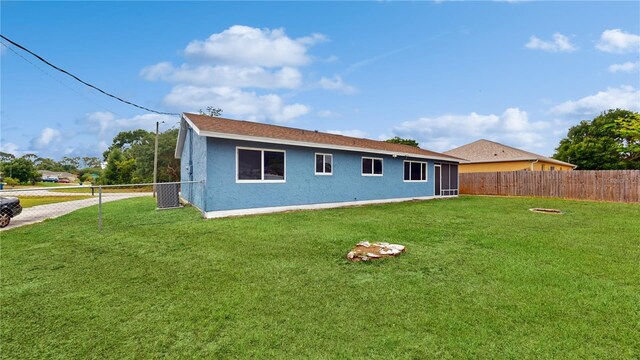 rear view of house with a lawn