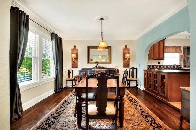 dining room featuring ornamental molding and dark hardwood / wood-style floors