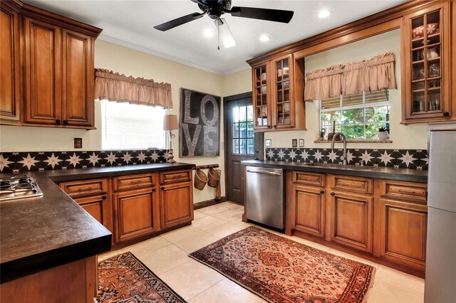 kitchen featuring dishwasher, sink, ceiling fan, and light tile flooring