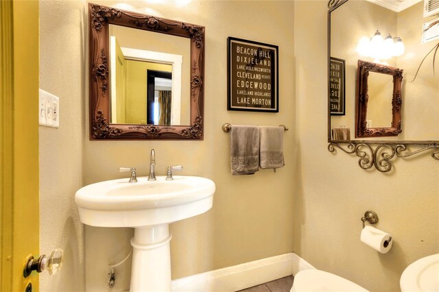 bathroom with tile flooring and toilet