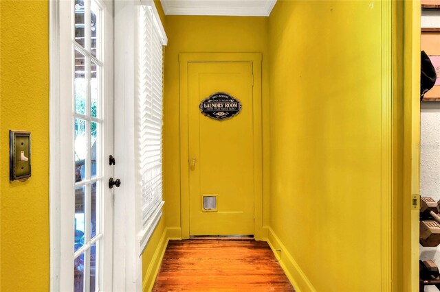 doorway to outside with hardwood / wood-style floors, french doors, and crown molding