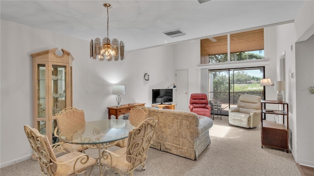 dining space featuring light colored carpet and a notable chandelier