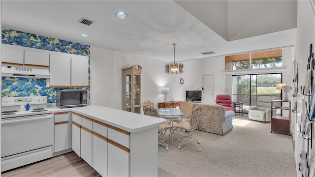 kitchen featuring decorative light fixtures, ventilation hood, white cabinetry, white electric range oven, and kitchen peninsula